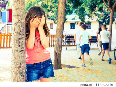 Playing hide and seek. Girl covering eyes her hands 112898816