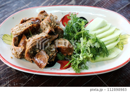 Grill Northern Thai Sausage with herbal vegetables on white dish Grill Northern Thai Sausage with herbal vegetables on white dish 112898983