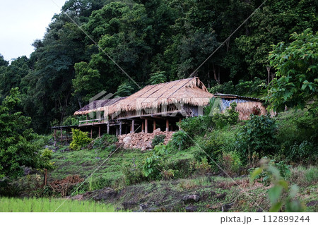 Local hut and homestay village on terraced Paddy rice fields on mountain in the countryside, Chiangmai Province of Thailand. Travel in greenery tropical rainy season concept 112899244