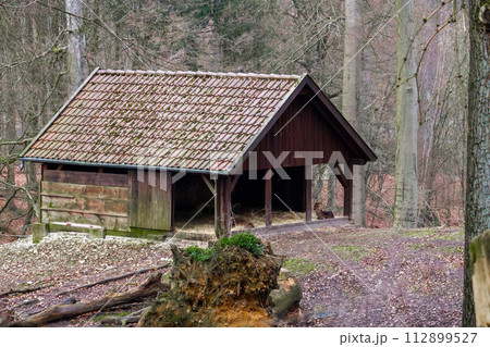 Manger with hay for the reindeer in the forest. Manger with hay for the reindeer in the forest. 112899527