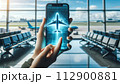 A hand holds a phone displaying a 3D airplane hologram, 112900881