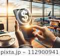 A hand holds a mobile phone with a simple 3D dollar coin hologram floating outside 112900941