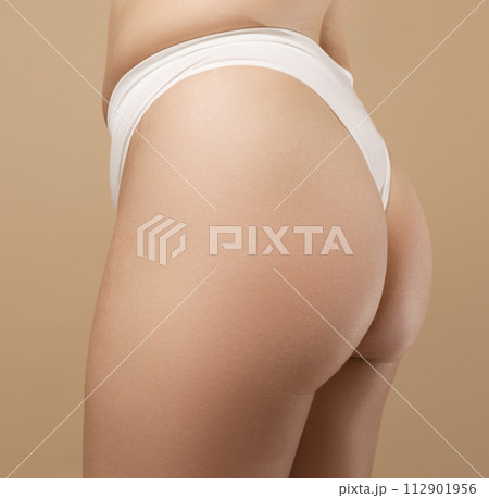 A woman's hand holds a fat cellulite and a stretch A woman's hand holds a fat cellulite and a stretch 112901956