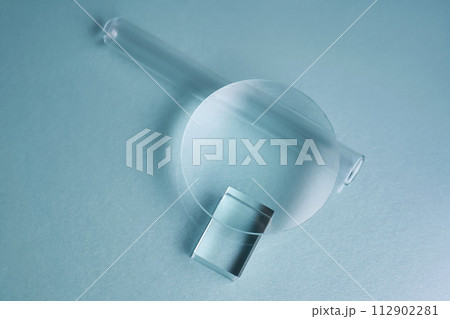 Glass objects and prisms on a blue background. Glass objects and prisms on a blue background. 112902281