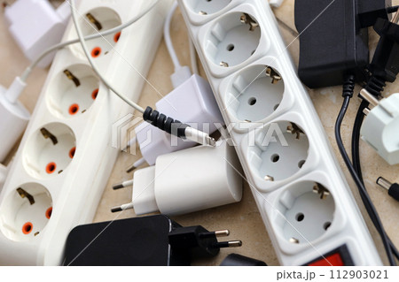 Many electrical plugs network congestion. The concept of electrical dependence. Lots of power plugs near power outlets 112903021