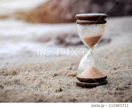 Sand Clock on Sandy Beach. Generative AI 112903711