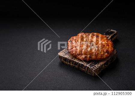 Delicious fresh grilled chicken fillet with spices and herbs Delicious fresh grilled chicken fillet with spices and herbs 112905300