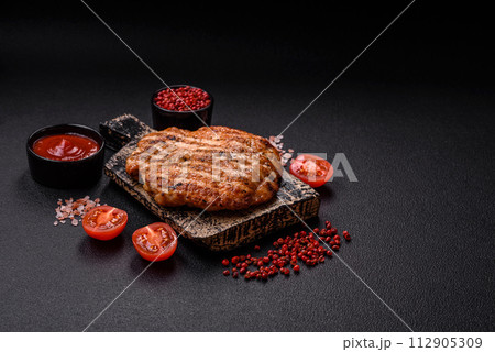 Delicious fresh grilled chicken fillet with spices and herbs Delicious fresh grilled chicken fillet with spices and herbs 112905309