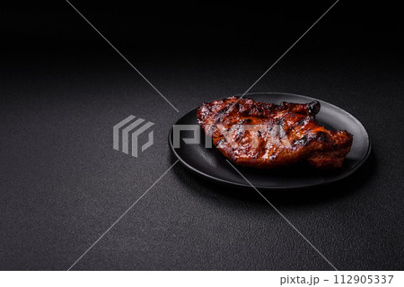 Fresh juicy delicious beef steak on a dark background Fresh juicy delicious beef steak on a dark background 112905337