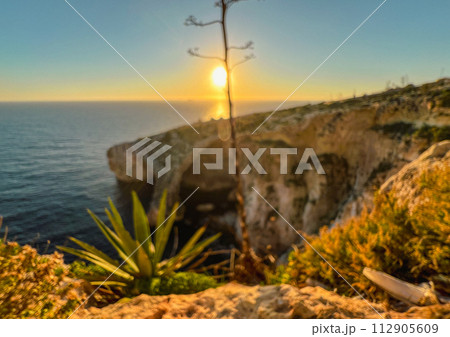 Wied iz-Zurrieq harbour and Blue Grotto sea caves are located on the coastline opposite to the small islet of Filfla. Wied iz-Zurrieq harbour and Blue Grotto sea caves are located on the coastline opposite to the small islet of Filfla. 112905609