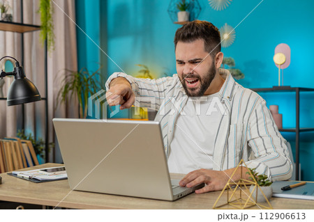 Nervous stressed angry Caucasian manager quarrelling laptop video call online at home office webinar 112906613