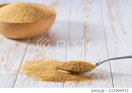 metal spoon with organic amaranth seen on a light table, selective focus. 112906972