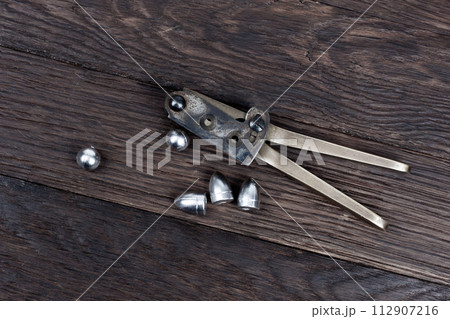 Antique old west bullet mold with bullets for revolver. 112907216