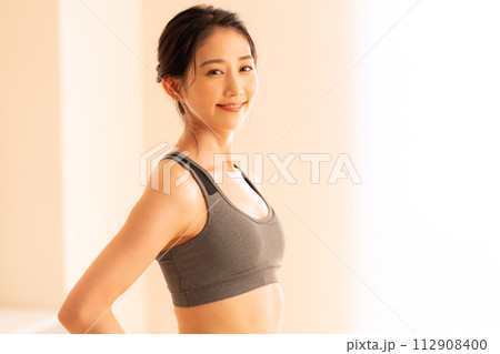ホットヨガをする若い女性 112908400