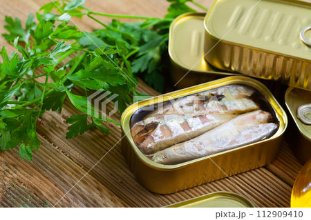 Preserved mackerel fish on wooden table 112909410