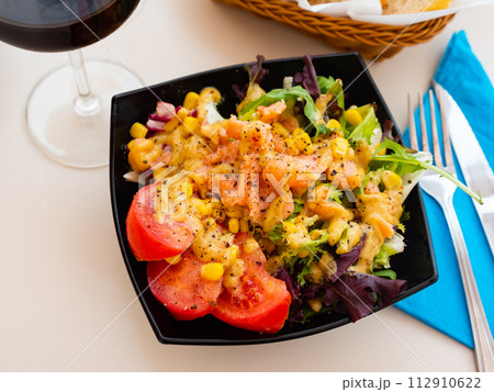 Salad with smoked salmon, tomato, corn, greens 112910622