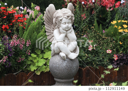 the Statue child angle among pink flower. 112911149