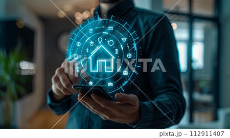 smartphone with digital hologram of smart home system and real estate icons, closeup view 112911407