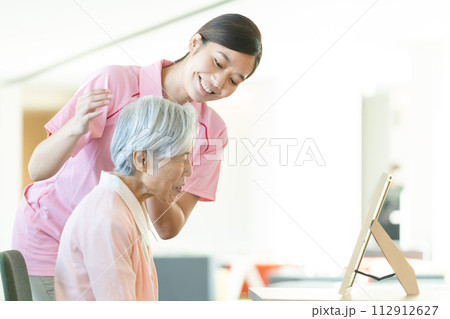 若い介護士とシニア女性 112912627