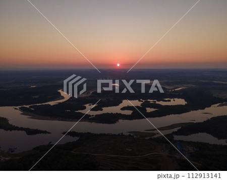 Amazing view of sunset over river in evening Amazing view of sunset over river in evening 112913141