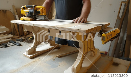 worker in a carpentry workshop inside a carpentry workshop 112913800