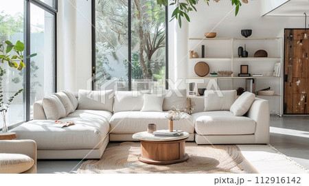 Modern living room with bright, simple tones and natural light. 112916142