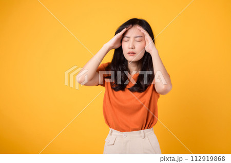 Asian woman distressed expression captures the realities of stress, headache, and discomfort, reflecting her emotional state. Asian woman distressed expression captures the realities of stress, headache, and discomfort, reflecting her emotional state. 112919868