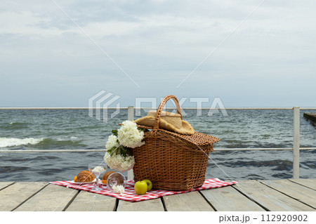 The concept of a picnic by the sea, with flowers. 112920902