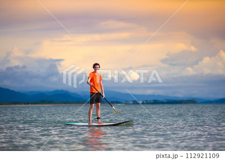Man on stand up paddle. Water and beach sport 112921109