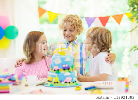 Kids birthday party. Child blowing out cake candle Kids birthday party. Child blowing out cake candle 112921392