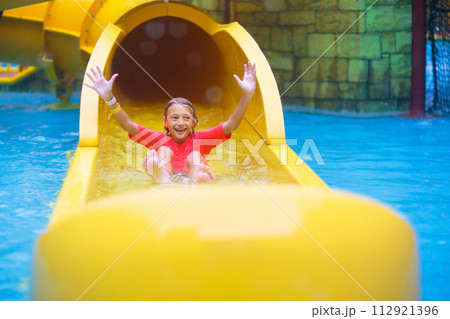 Kids on water slide. Family in aqua theme park. 112921396