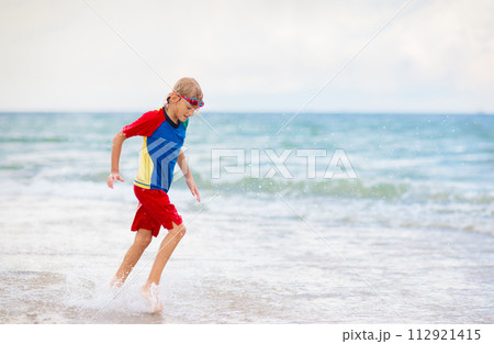 Kids playing on beach. Children play at sea. 112921415