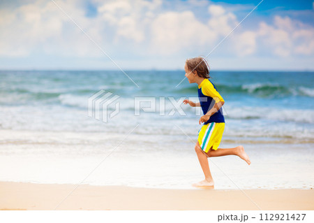 Kids playing on beach. Children play at sea. 112921427