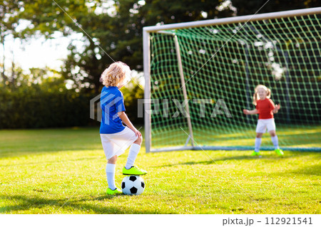 Kids play football. Child at soccer field. 112921541