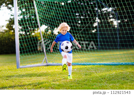 Kids play football. Child at soccer field. Kids play football. Child at soccer field. 112921543