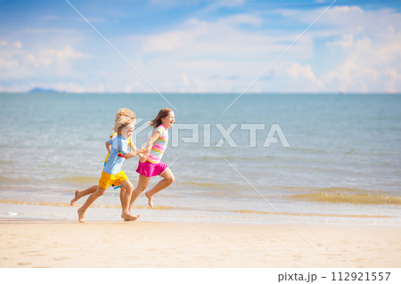 Kids play on tropical beach. Sand and water toy. Kids play on tropical beach. Sand and water toy. 112921557