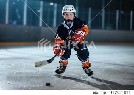 Boy dressed as a hockey player on ice rink.	AI-generated item 112921896