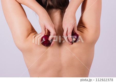 Topless woman with an onion on a white background Topless woman with an onion on a white background 112922378