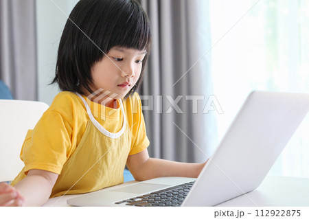 little asian girl student study online using laptop computer at home 112922875