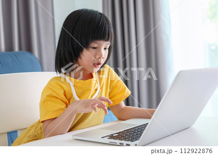 little asian girl student study online using laptop computer at home 112922876