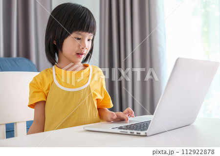 little asian girl student study online using laptop computer at home little asian girl student study online using laptop computer at home 112922878