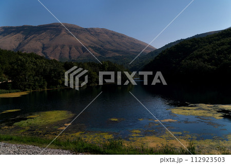 Lake Turin on border of Macedonia and Albania Clear water sunrise or sunset blue sky. High quality  112923503