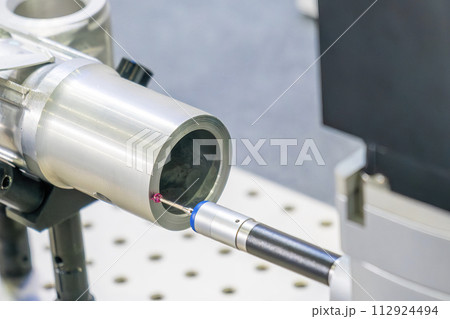 The multi axis CMM machine measuring the aluminum automotive parts. The multi axis CMM machine measuring the aluminum automotive parts. 112924494