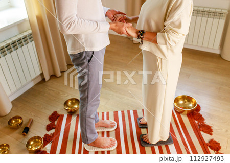 couple in love morning yoga practice with sadhu nails. mans and womans foot on the wooden desk with sharp metal nails 112927493