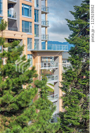 High-rise residential building with big patio on bright sunny day 112928082