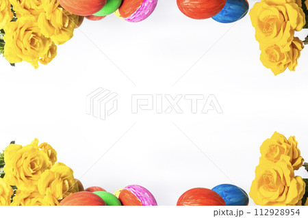 Colorful easter eggs and yellow roses on white background with copy space for text Colorful easter eggs and yellow roses on white background with copy space for text 112928954