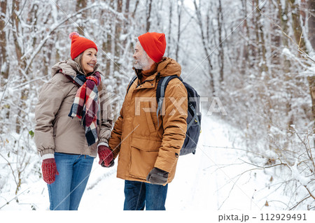Mature couple in a snowy forest feeling excited Mature couple in a snowy forest feeling excited 112929491