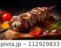 AI-generated content. Shish kebab on a skewer on a wooden board served with tomatoes onions and herbs dark photo AI-generated content. Shish kebab on a skewer on a wooden board served with tomatoes onions and herbs dark photo 112929833