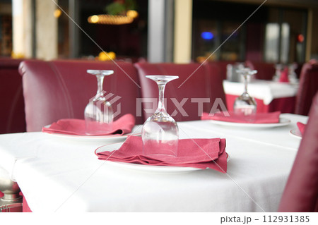 served and decorated round festive table in a restaurant served and decorated round festive table in a restaurant 112931385
