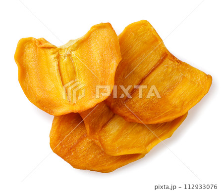 Pieces of dried persimmon close-up on a white. Top view Pieces of dried persimmon close-up on a white. Top view 112933076